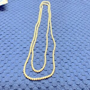 Long string of manmade pearls.